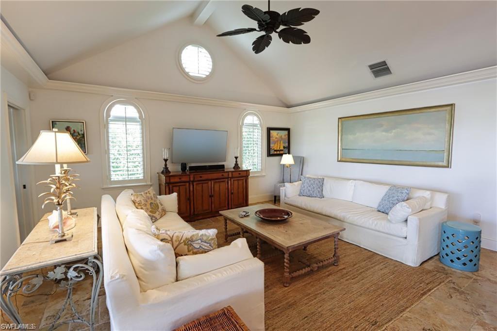 2201 Beacon Lane Naples, FL 34103 - Photo 12 of 34 a living room with furniture a window and a flat screen tv
