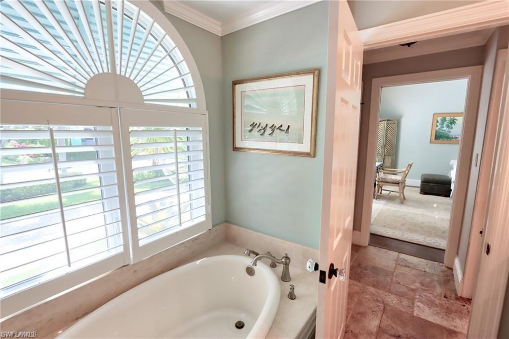 2201 Beacon Lane Naples, FL 34103 - Photo 18 of 34 a bathroom with a bathtub and a shower