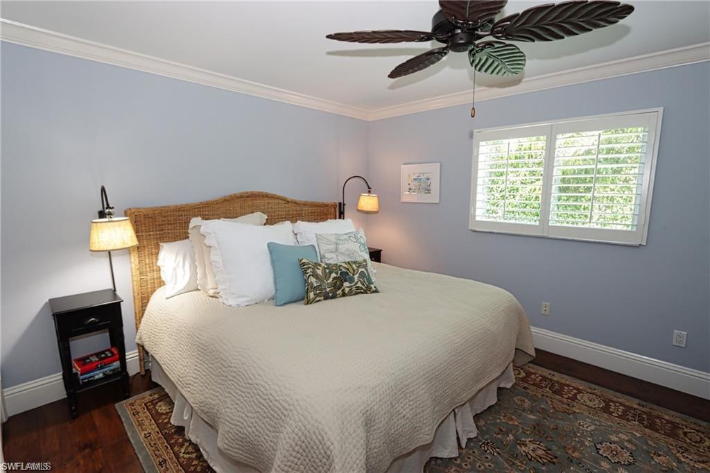 2201 Beacon Lane Naples, FL 34103 - Photo 19 of 34 a bedroom with a bed and a tv