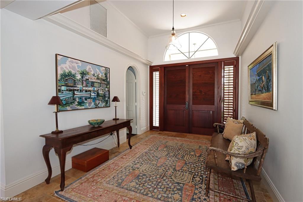 2201 Beacon Lane Naples, FL 34103 - Photo 2 of 34 a living room with furniture a window and a flat screen tv