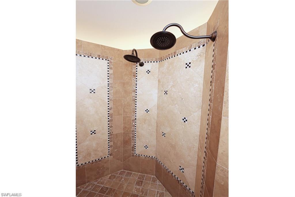 2201 Beacon Lane Naples, FL 34103 - Photo 22 of 34 a bathroom with a shower and a mirror