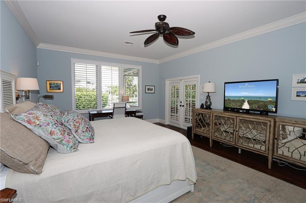 2201 Beacon Lane Naples, FL 34103 - Photo 24 of 34 a bedroom with a bed and a flat screen tv