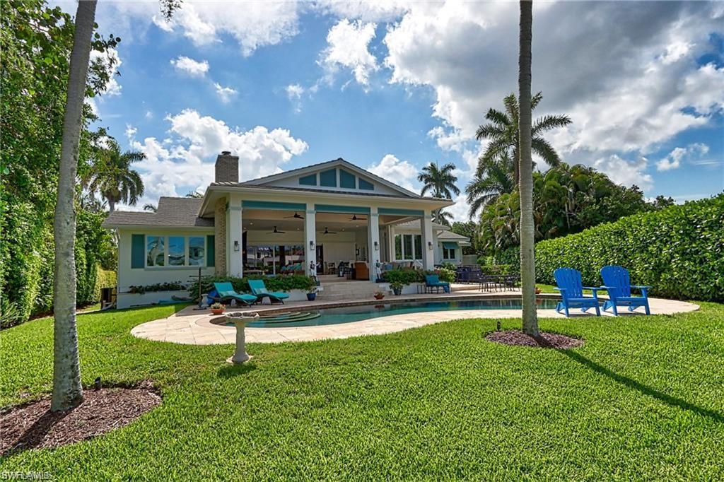 2201 Beacon Lane Naples, FL 34103 - Photo 32 of 34 a front view of a house with swimming pool and garden