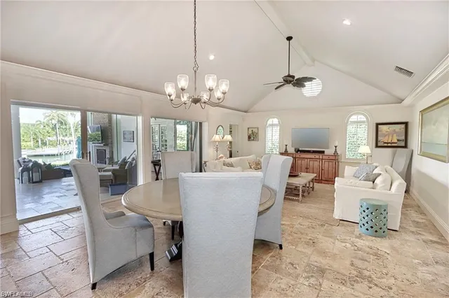 a view of a dining room with furniture wooden floor and chandelier