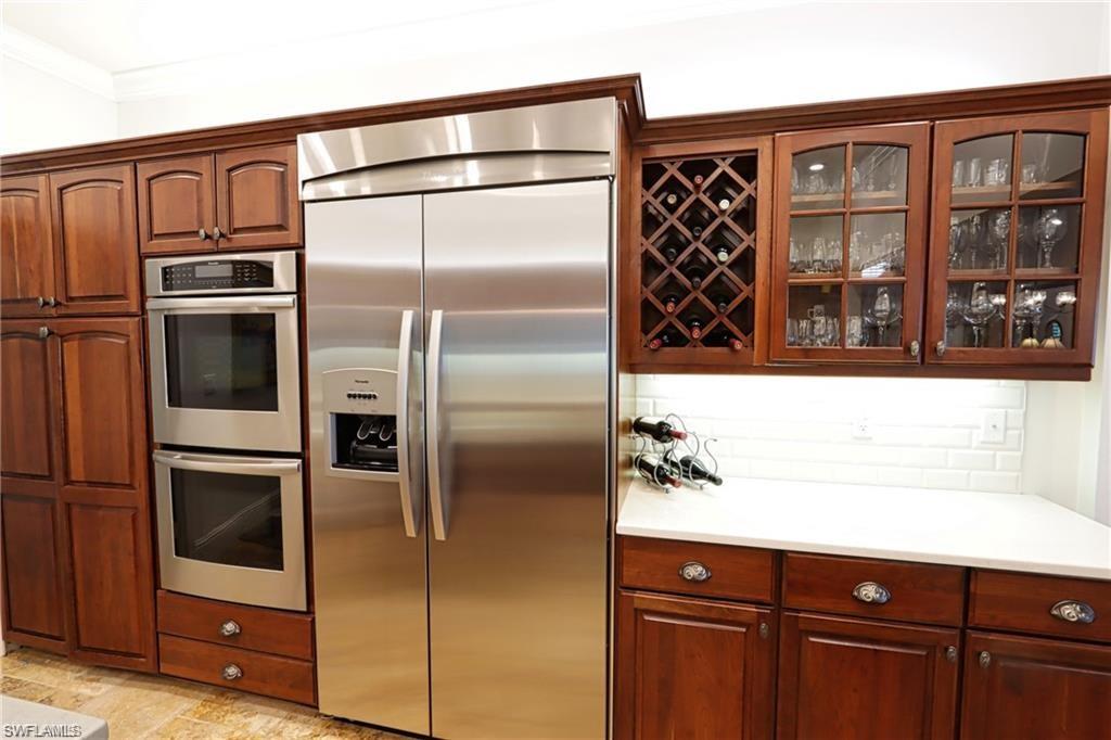 2201 Beacon Lane Naples, FL 34103 - Photo 10 of 34 a kitchen with a refrigerator and a sink