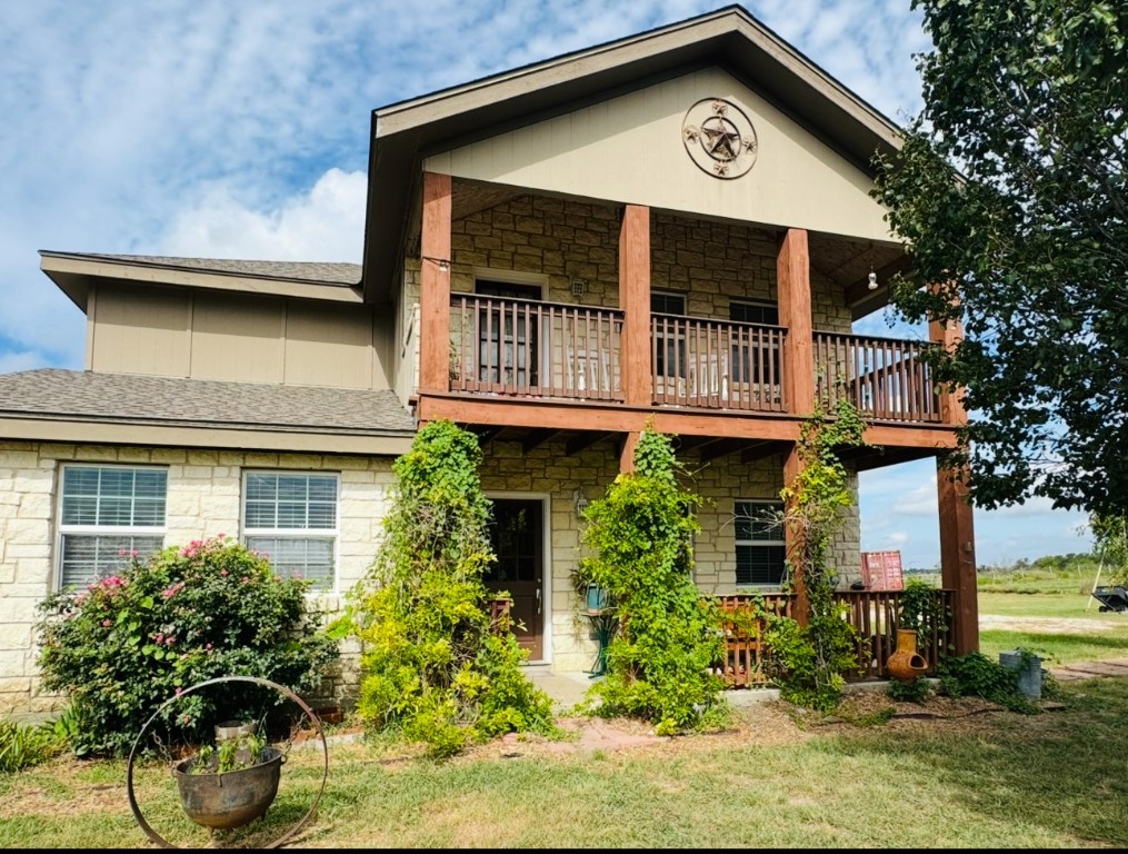 2334 County Road 464 Elgin, TX 78621 - Photo 2 of 39 a view of a house with potted plants and a yard