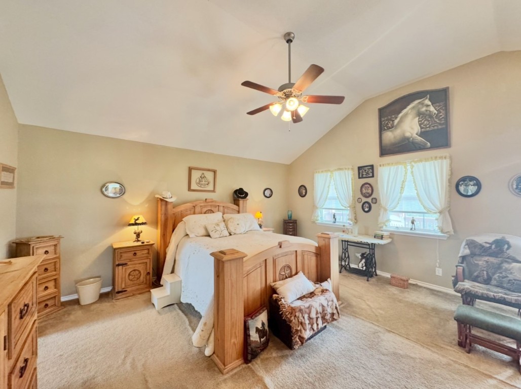 2334 County Road 464 Elgin, TX 78621 - Photo 22 of 39 a bed room with a bed and a chandelier