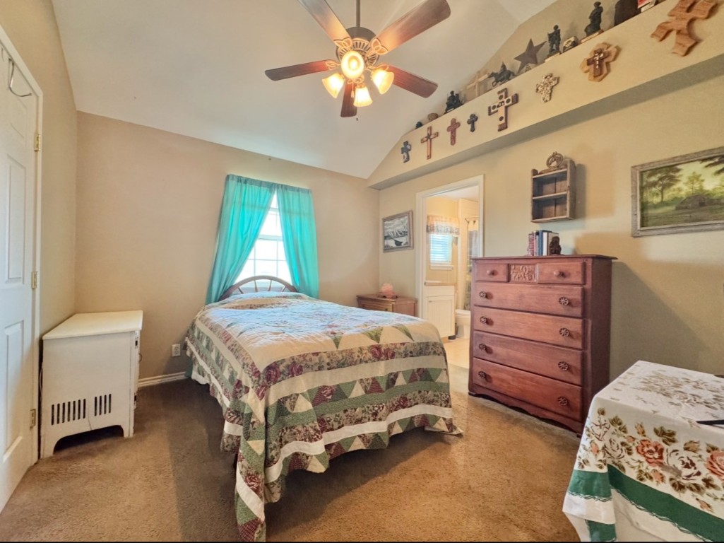 2334 County Road 464 Elgin, TX 78621 - Photo 26 of 39 a bedroom with a bed and a chandelier