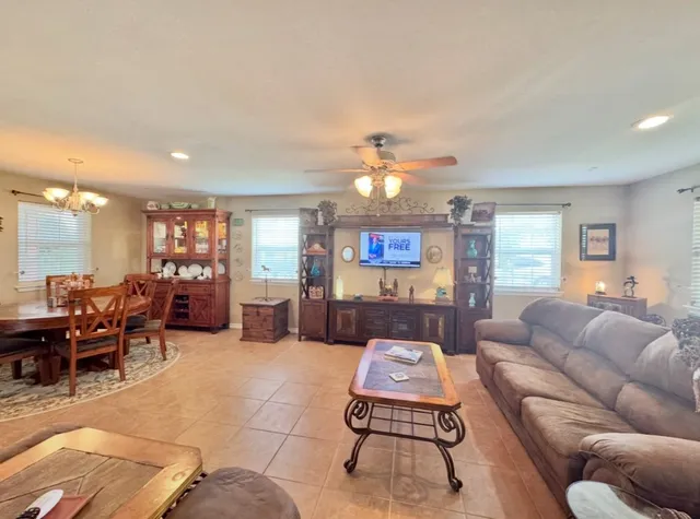 a living room with furniture kitchen view and a table