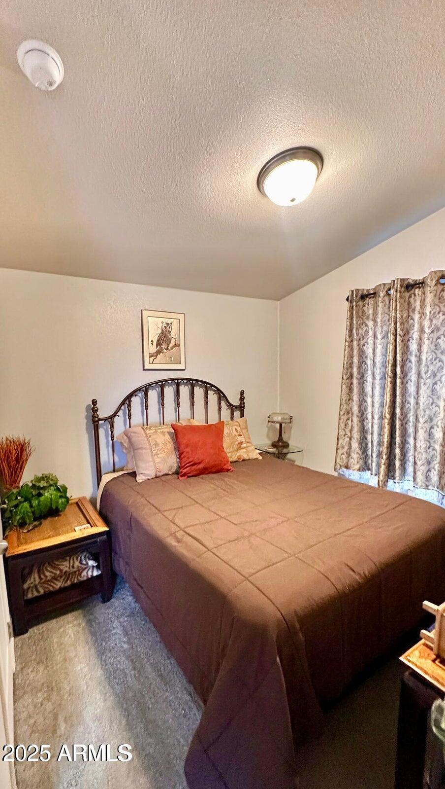 8102 White Mountain Lake Road Show Low, AZ 85901 - Photo 7 of 8 a bedroom with a bed and a dresser