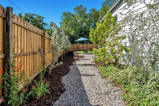 a view of a backyard with pathway