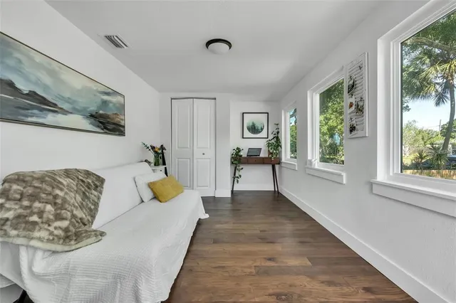 a living room with furniture and a lamp