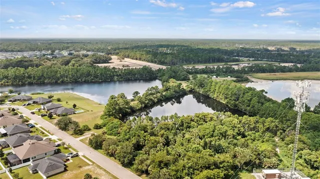 view of a lake with houses in the back