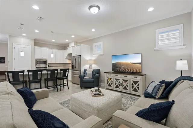 a view of a dining room with furniture and chandelier