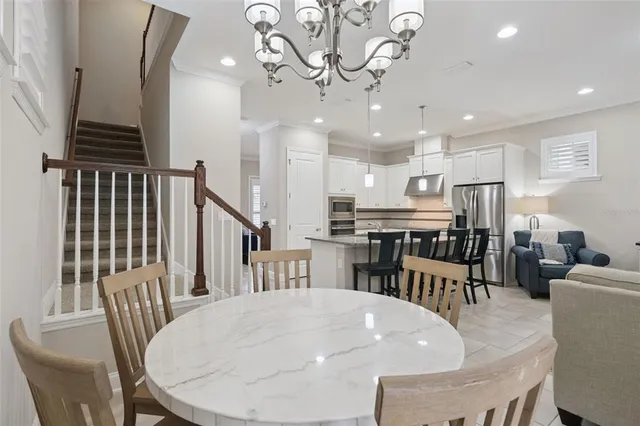 a view of a dining room with furniture and a chandelier