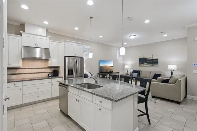 a kitchen with cabinets and stainless steel appliances