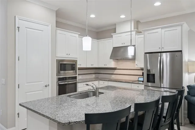 a bedroom with a large bed and a tv on dresser