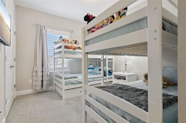 a view of a swimming pool with lawn chairs under an umbrella