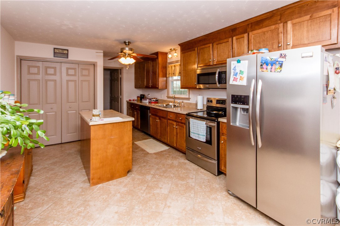 1101 Covington Road Colonial Heights, VA 23834 - Photo 14 of 47 a kitchen with stainless steel appliances a refrigerator a stove a sink a oven with a dining table and chairs