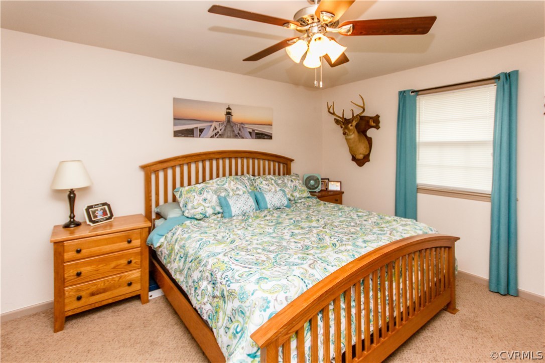 1101 Covington Road Colonial Heights, VA 23834 - Photo 21 of 47 a bedroom with a bed and a chandelier