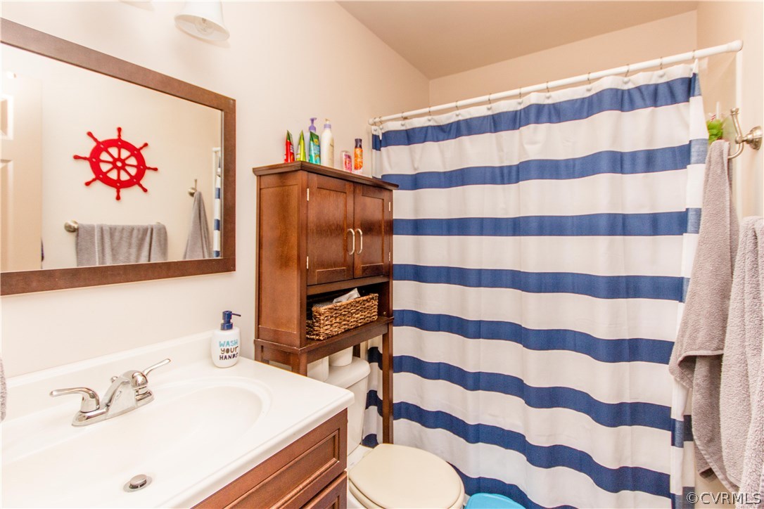 1101 Covington Road Colonial Heights, VA 23834 - Photo 27 of 47 a bathroom with a sink toilet and a mirror