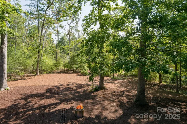 a front view of a house with a yard and a garden