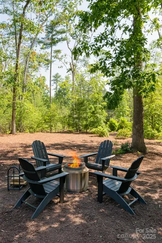 a view of house with a deck front of house