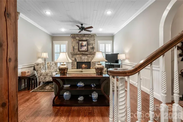 a bathroom with a tub a window and glass door shower
