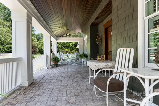 a view of balcony with furniture and garden
