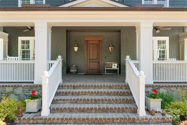 a kitchen with stainless steel appliances granite countertop a stove a refrigerator a kitchen island a dining table and chairs