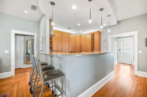 a large kitchen with kitchen island granite countertop counter space a sink stainless steel appliances and cabinets