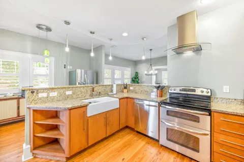 a kitchen with stainless steel appliances granite countertop a refrigerator and a sink