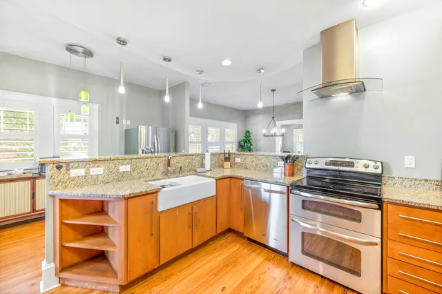 a kitchen with stainless steel appliances granite countertop a refrigerator and a sink