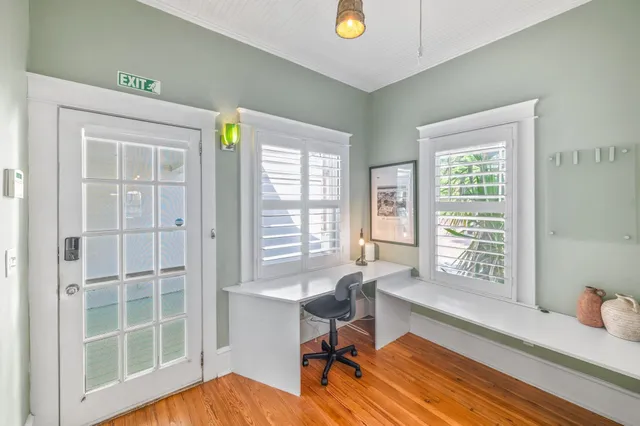 a view of a hallway with wooden floor and lamp