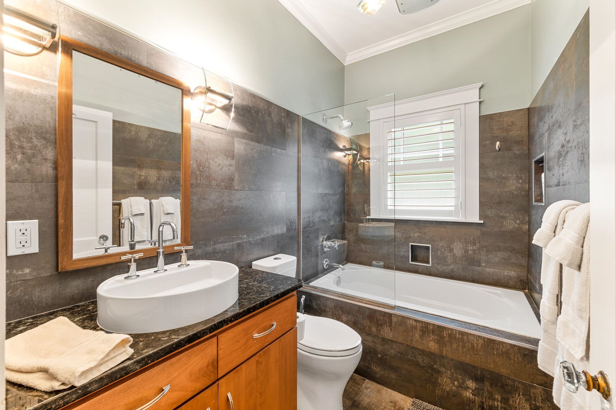 20 Riberia Street St. Augustine, FL 32084 - Photo 29 of 56 a bathroom with a granite countertop sink toilet a mirror and bathtub