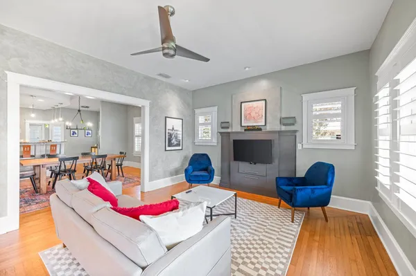 a living room with furniture and a wooden floor