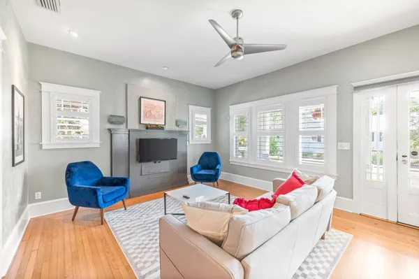 a living room with furniture and wooden floor