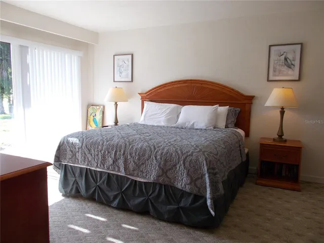 a bedroom with a bed and a lamp