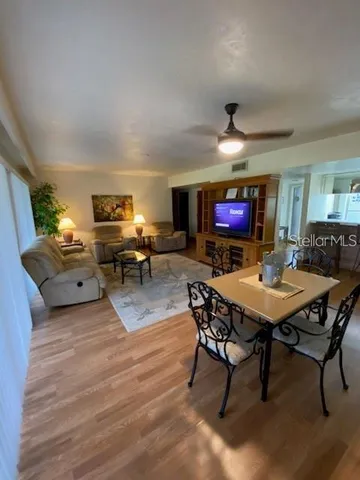 a living room with furniture a dining table and a piano