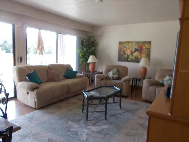 a living room with furniture and a large window