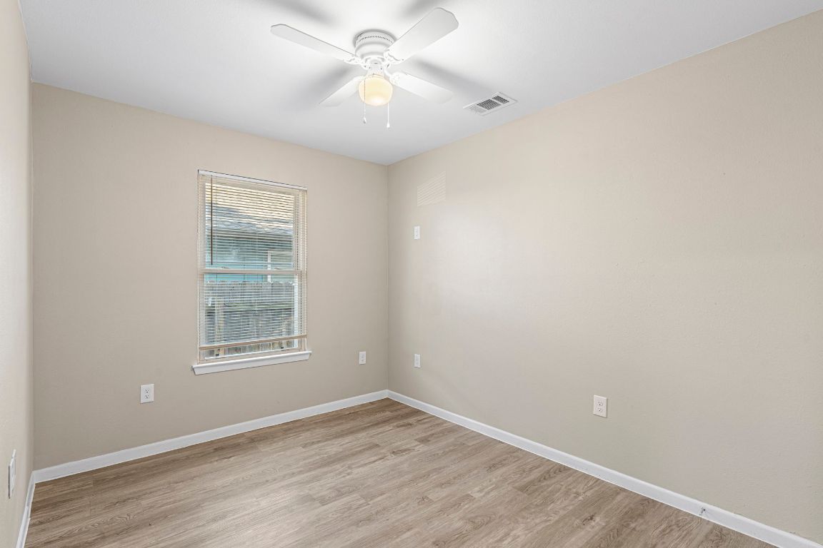 7307 Thannas Way Austin, TX 78744 - Photo 10 of 20 an empty room with a window and a fan