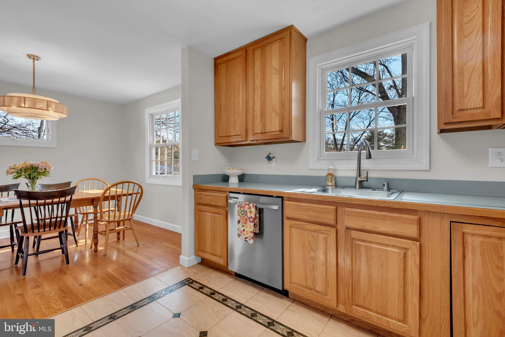 5 Spring Haven Court Severna Park, MD 21146 - Photo 12 of 35 a kitchen with stainless steel appliances granite countertop a stove a sink dishwasher a dining table and chair with wooden floor