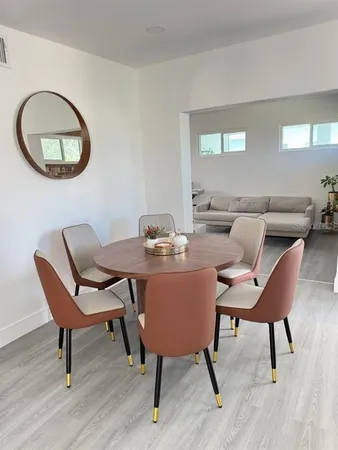 a dining room with furniture and a wooden floor