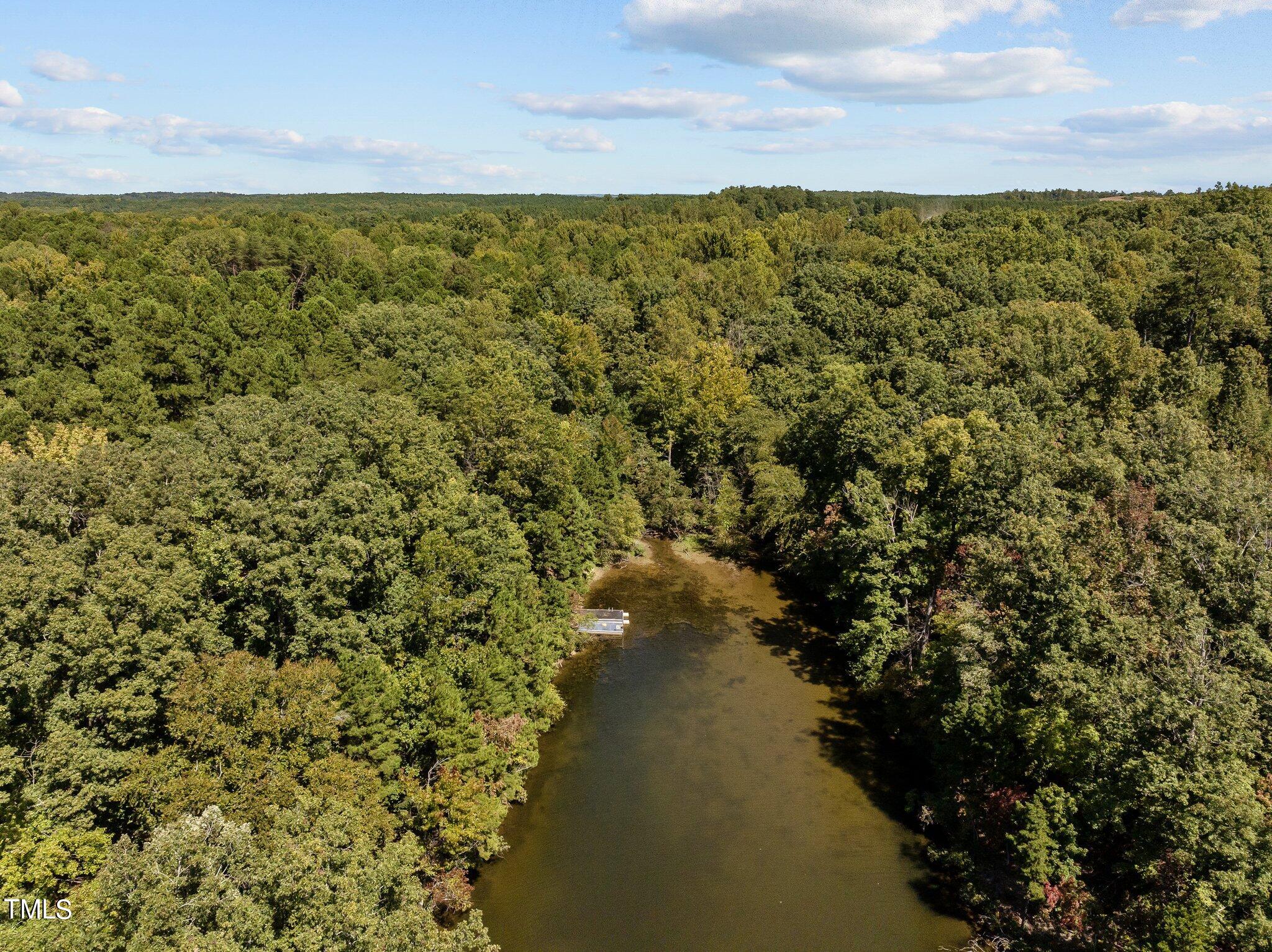 17.03-ac New Mayo Drive Roxboro, NC 27574 - Photo 11 of 14 a view of a lake with a building in the background
