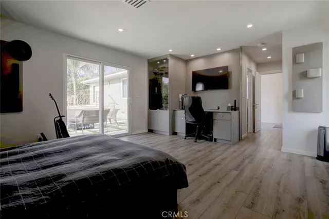 a living room with furniture a flat screen tv and a floor to ceiling window