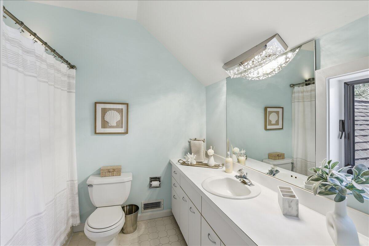 100 Mid-Iron Way, Unit 7027 Mashpee, MA 02649 - Photo 21 of 38 a bathroom with a toilet sink and mirror