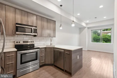 a kitchen with a stove microwave and sink