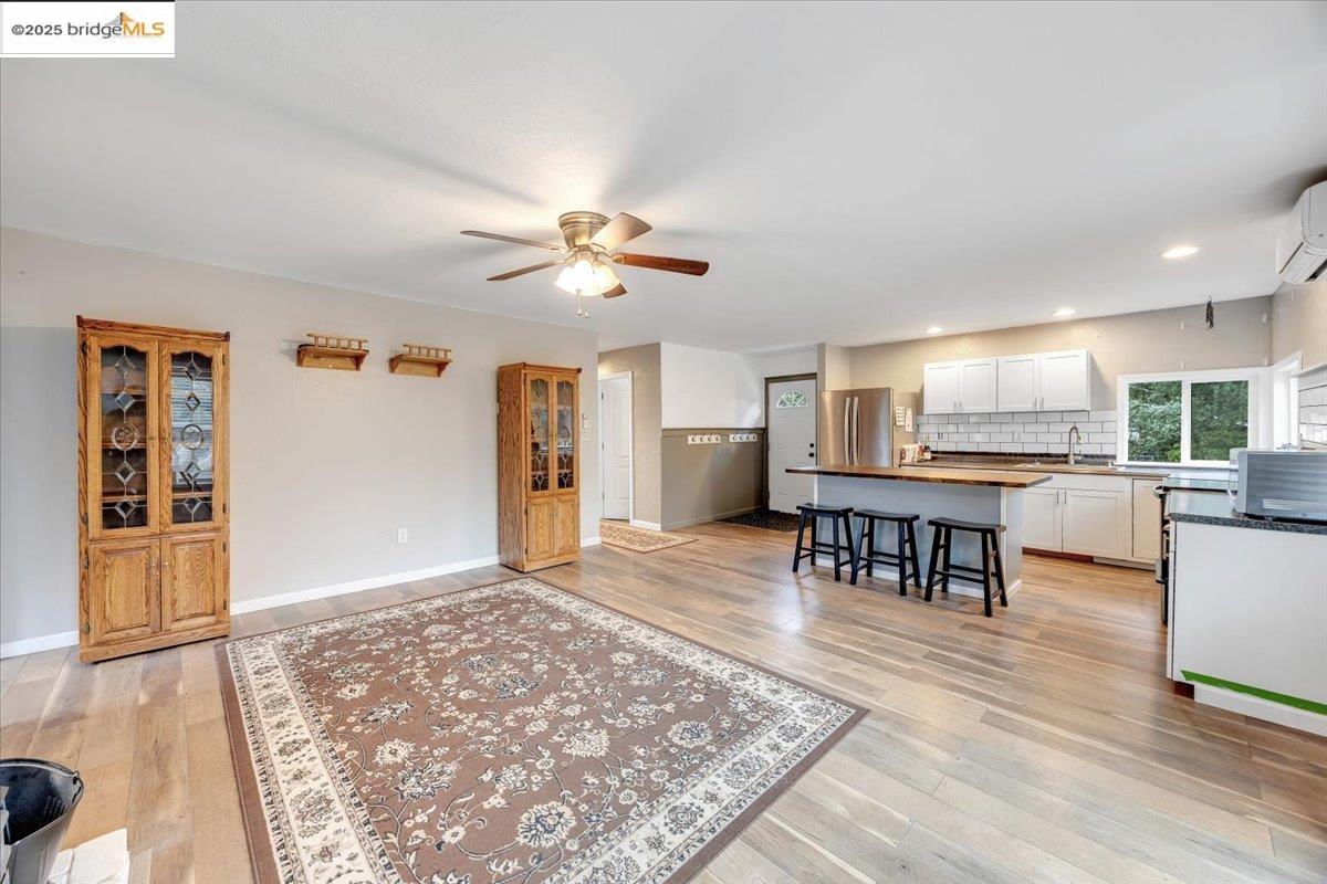 21980 Montgomery Road Sonora, CA 95370 - Photo 11 of 52 Living area with recessed lighting, ceiling fan, a wall mounted AC, and light wood-style flooring