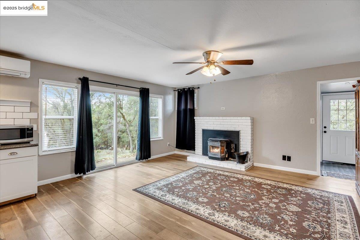 21980 Montgomery Road Sonora, CA 95370 - Photo 11 of 52 a view of a livingroom with a fireplace a ceiling fan and a fireplace