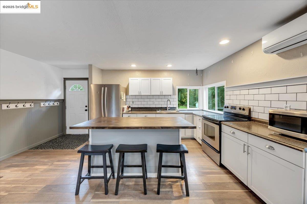 21980 Montgomery Road Sonora, CA 95370 - Photo 13 of 52 a kitchen with stainless steel appliances granite countertop a table chairs sink and cabinets
